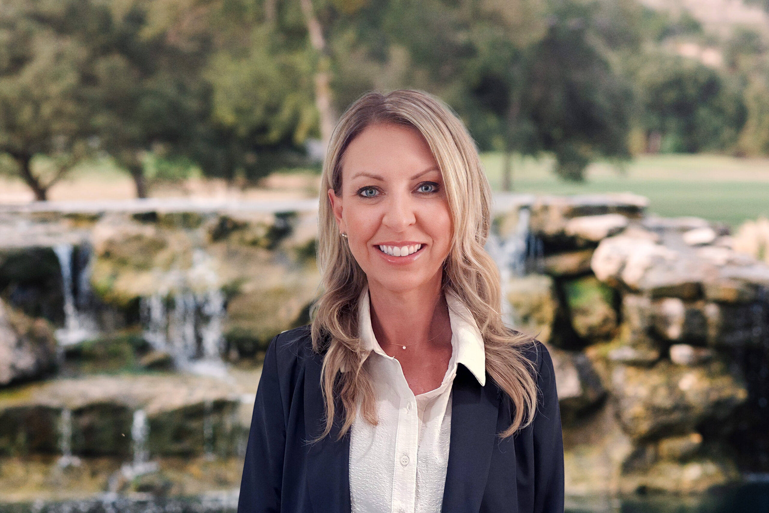 A woman standing in front of some water